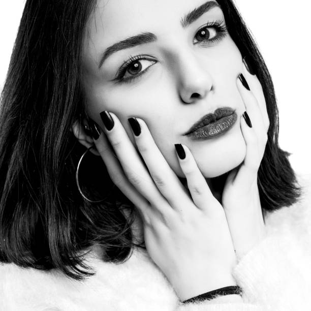 istock Black and white young woman touching her face isolated on white background. 1226813491