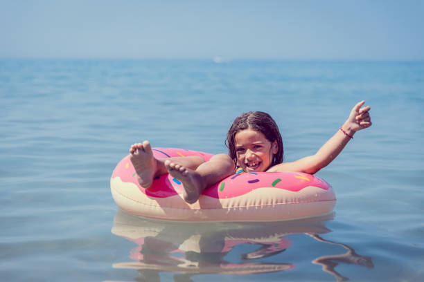 istock Girl floating on water donut swimming ring 1226816057
