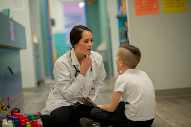 istock Speech therapist sitting with a child 1226816247