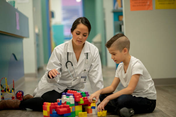 istock Speech therapist sitting with a child 1226816255