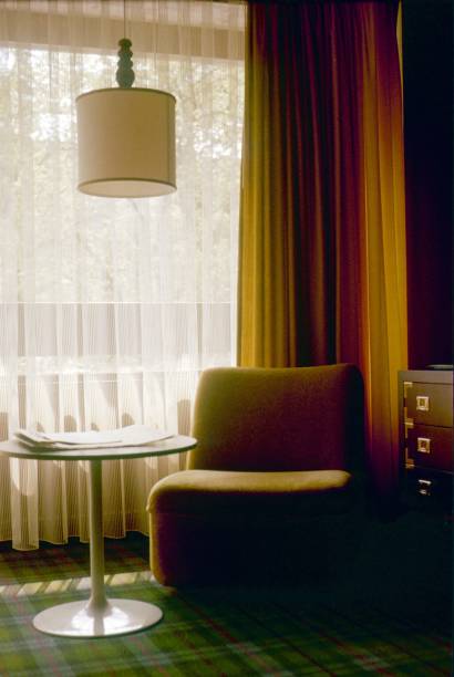 Frankfurt a. M., Germany, 1976. Modern seating with table and lamp in front of a window.