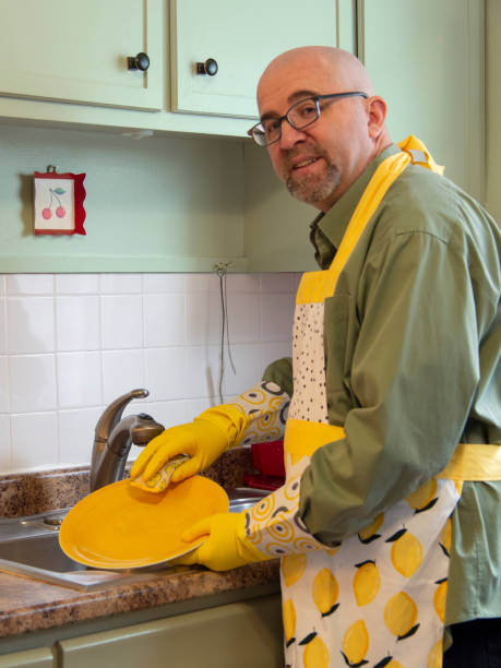 istock Man washing dishes by hand 1226817219