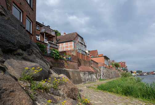 Old town of Lauenburg, coastal promenade and historic brick houses on the dike wall made of field stones on the river Elbe in northern Germany, Europe, copy space