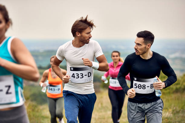 istock Young athletic men talking while running marathon in nature. 1226823170