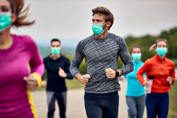 istock Group of runners wearing protective face masks while participating in a marathon. 1226824132