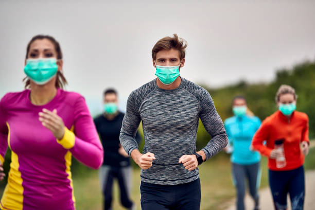 istock Young sportsman running marathon while wearing protective face mask. 1226824133
