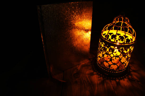 istock Candle lanterns on a rustic wooden table that lights up as a light source at the dark night 1226827461