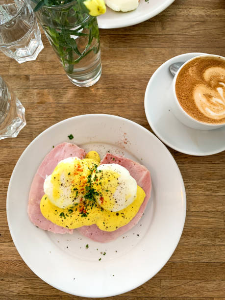 Egg benedict and flat white coffee