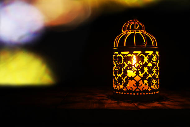 istock Candle lanterns on a rustic wooden table that lights up as a light source at the dark night 1226828655