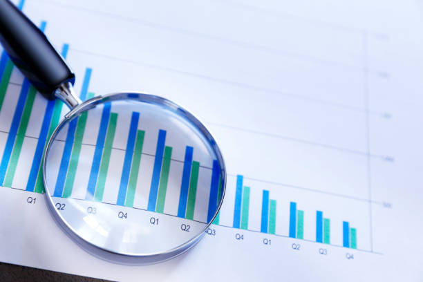 istock Magnifying Glass On Top Of Bar Chart Showing Declining Performance 1226831506