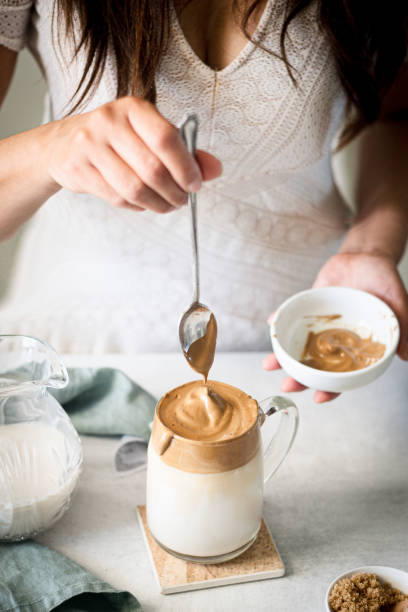 istock Dalgona Coffee, A woman in pouring fluffy whipped coffee on milk 1226832373