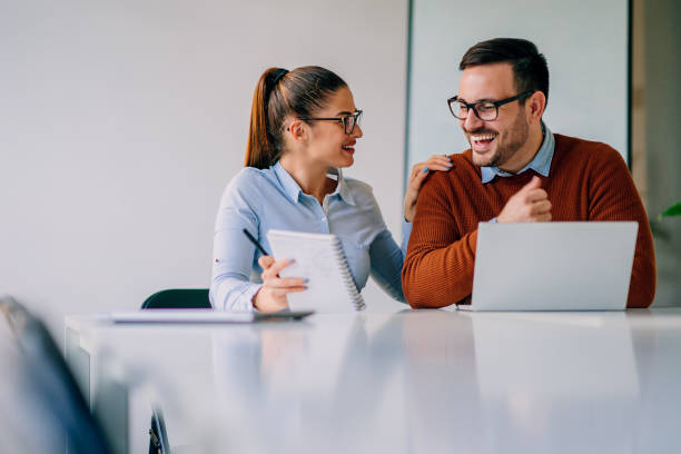 istock Young happy colleagues laughing at the meeting 1226833535