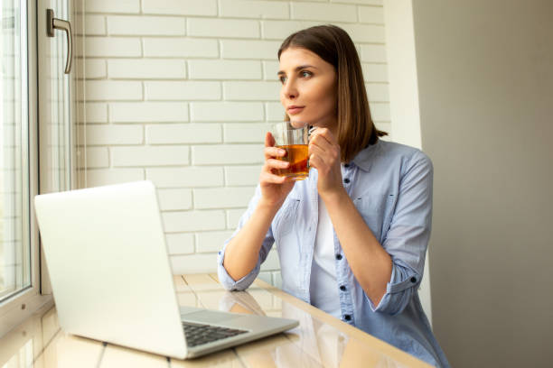 istock Pretty female enjoying tea sitting at table 1226834311