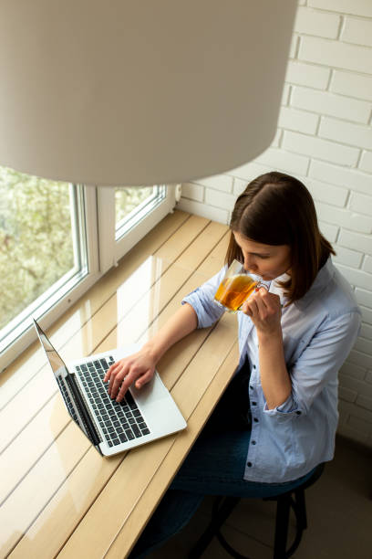 istock Woman drinking tea and sitting at table 1226834318