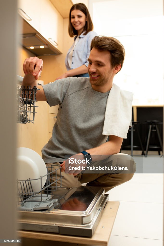 Man Using Kitchen Machine Happy Man Using Dishwasher In The Kitchen Stock Photo - Download Image ...