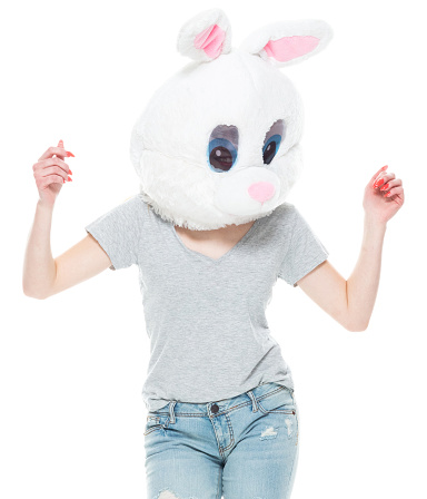One person of aged 18-19 years old who is beautiful with blond hair generation z young women dancing in front of white background wearing costume who is bizarre and wearing wearing a rabbit mask mask