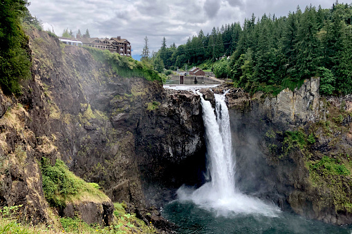 Waterfall east of Seattle, WA, with lodge in the background on a cloudy day. The lodge was used when filming the series Twin Peaks.