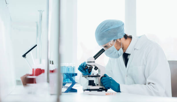 istock close up. scientist looking into the eyepiece of a microscope 1226840514