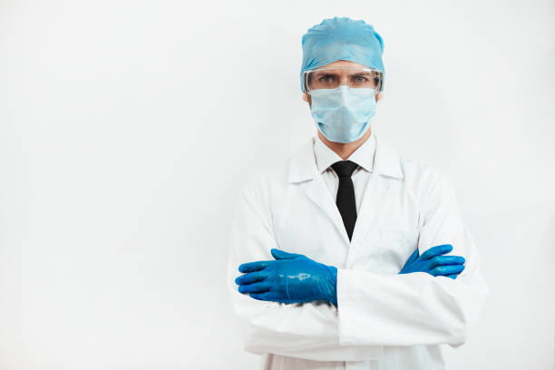 istock close up. serious doctor in a protective mask looking at you 1226840676
