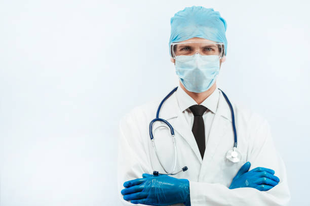 istock close up. serious paramedic in a protective mask looking at you 1226840683
