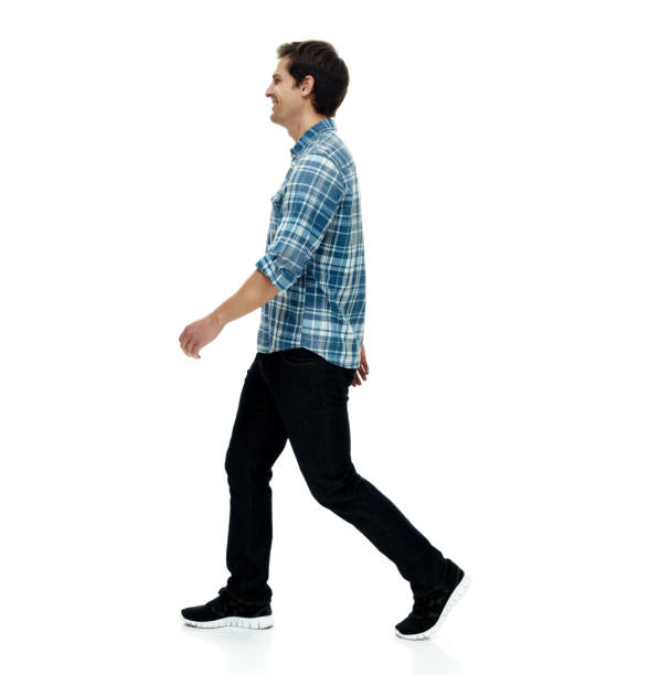 istock Caucasian male walking in front of white background wearing button down shirt 1226841663