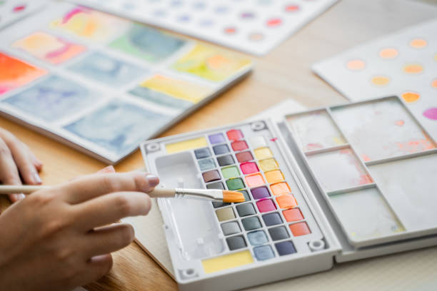 istock Students Artist painting a picture in sketching book. 1226841971