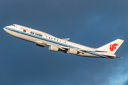 United States of America, New York: Air China Boeing 747-89L Registration B-2487, departing out of New York City's JFK International Airport on a day with cloudy skies