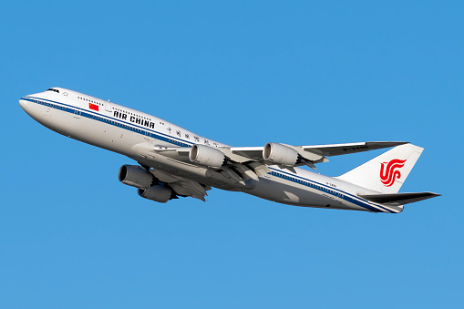 United States of America, New York: Air China Boeing 747-89L Registration B-2486, departing out of New York City's JFK International Airport on a day with clear blue skies