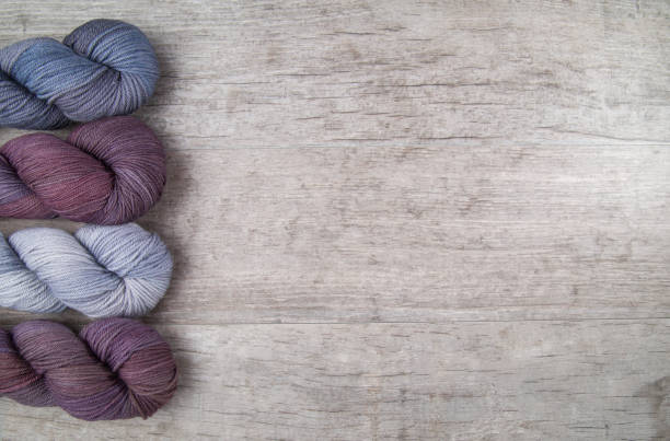 istock Purple skeins on a wood table 1226843743