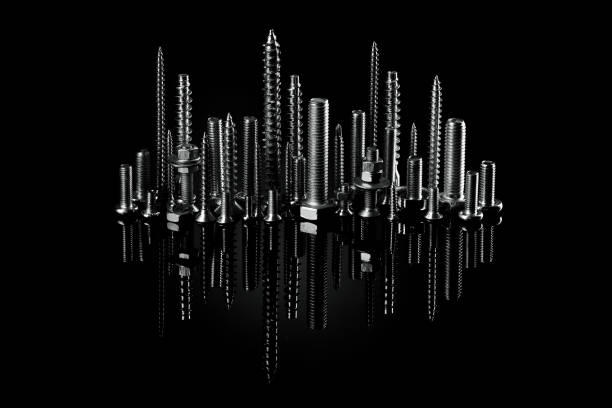 istock Screws and bolts on a black background. Small self-tapping screws and mounting screws. Consumable material for construction. 1226844920