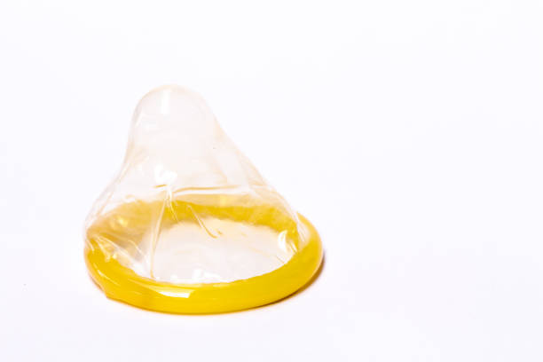 istock Yellow condoms on white background 1226845451