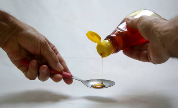 istock jar of honey pouring into spoon 1226847799