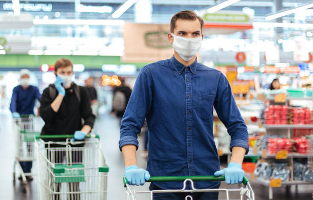 istock young man in a protective mask with a shopping cart 1226848508