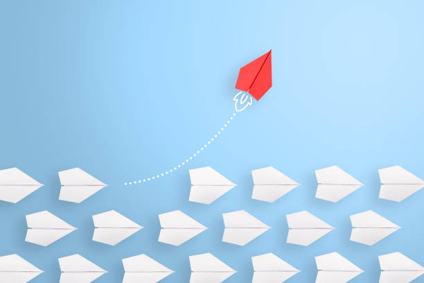 istock Change concepts with red paper airplane leading among white 1226850176
