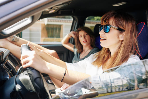 istock Woman in sunglasses driving car 1226851332
