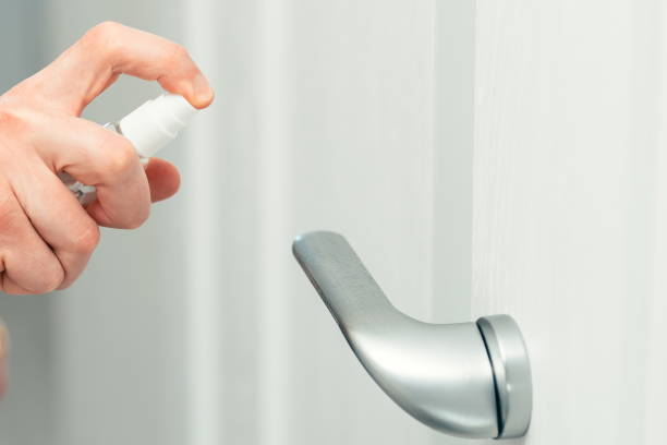 istock close up. employee using an antiseptic spray in the office 1226853965