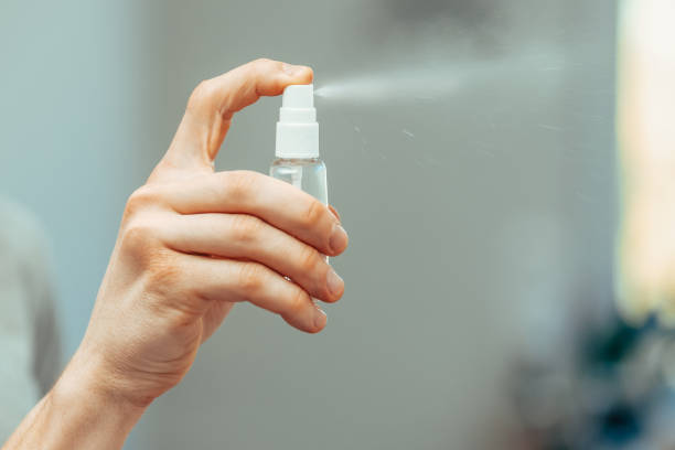 istock close up. employee using an antiseptic spray in the office 1226853972