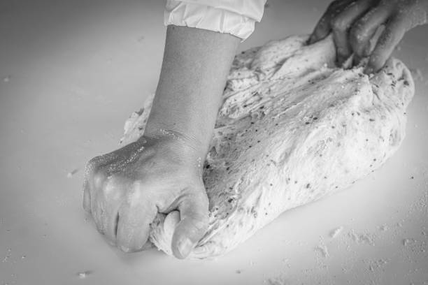 Man kneading a large dough for homemade bread in quarantine