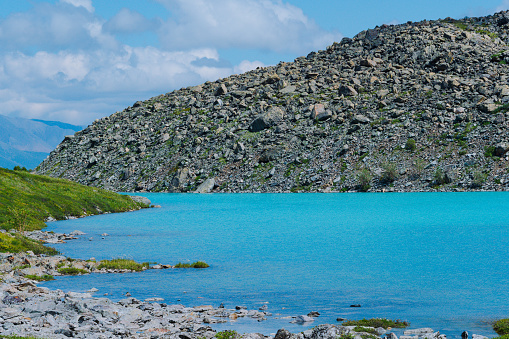 sea bay with stone shore, turquoise lake in rocks, mountain river with blue water