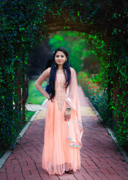 Portrait of young pretty Indian woman wearing traditional Indian dress Outdoor image of young beautiful Indian woman wearing traditional Indian dress or Salwar kameez and looking at camera. One person, horizontal composition with selective focus and copy space. beautiful traditional indian girl stock pictures, royalty-free photos & images