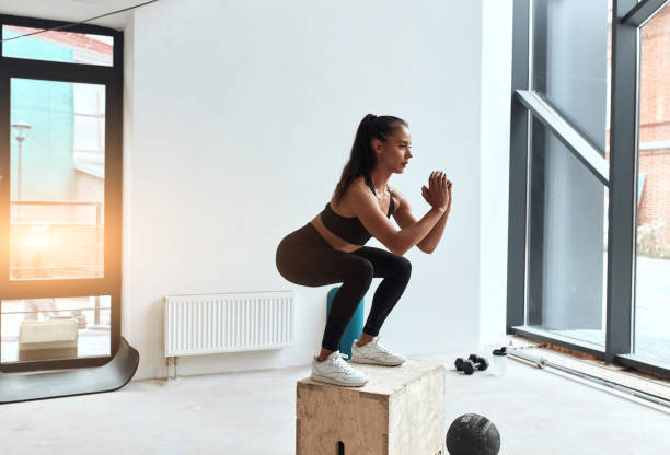 istock Athletic young woman jumping on fit box 1226866526