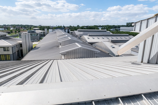 on a long building there is an aluminum roof with different roof domes