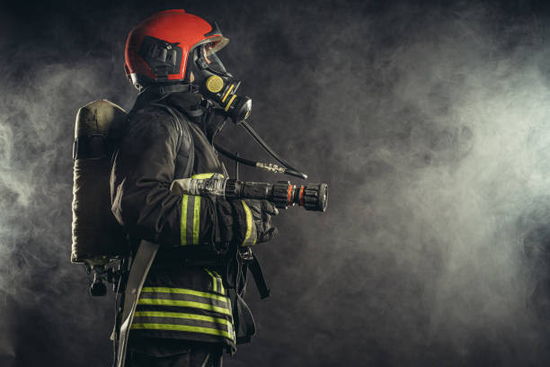 istock fireman in uniform in smoky background 1226867641