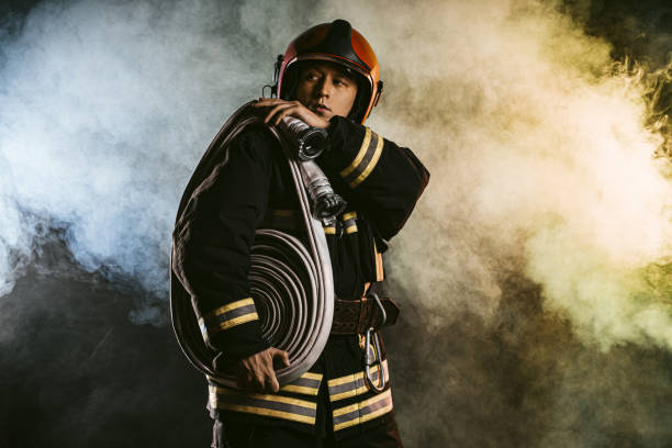 istock handsome firefighter isolated in smoky space 1226867685