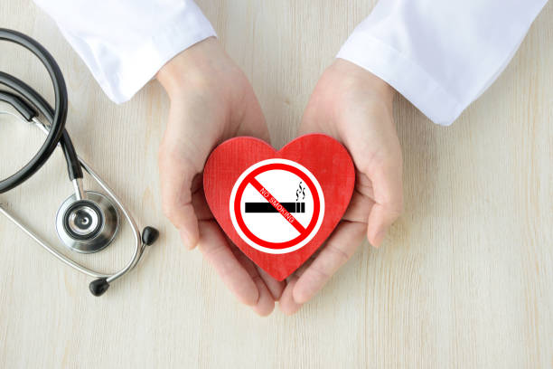 doctor having heart object with no smoking sticker - quitting imagens e fotografias de stock