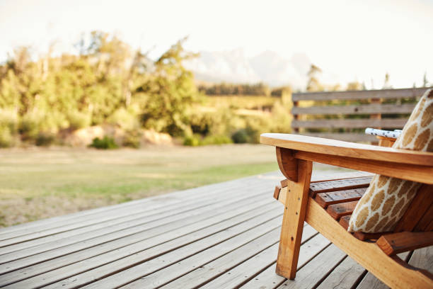 Let nature send your worries away Shot of wooden chairs on a deck out in a garden bed and breakfast stock pictures, royalty-free photos & images