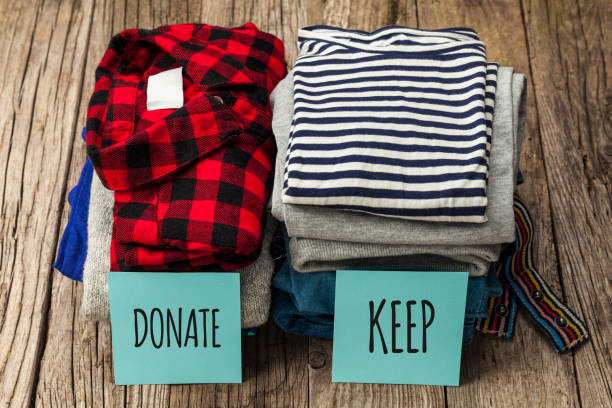 istock Stack of old clothes to discard (declutter) or keep. Recycle clothes, eco cotton 1226872689