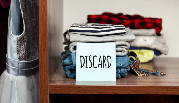 istock Stack of old clothes to discard (declutter) or donate. Recycling fabric cotton 1226872690
