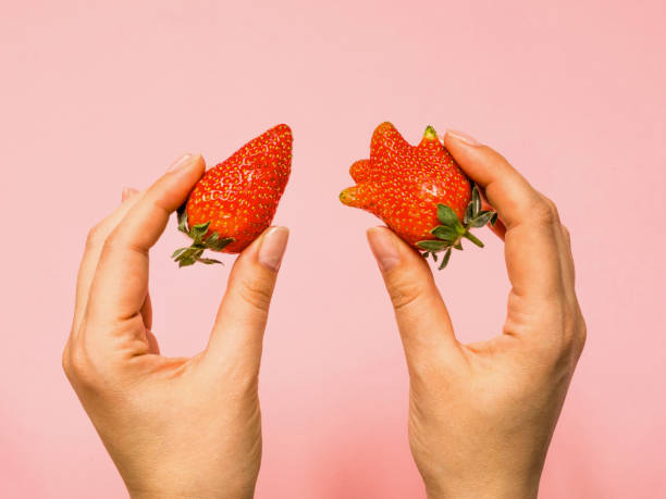 istock Usual and ugly strawberry in a woman hands 1226872909
