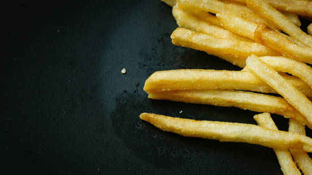 istock French fries on black plate for food content. 1226875170